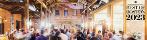 An image of Boston Harbor Distillery interior with a group of people blurred as if in motion.