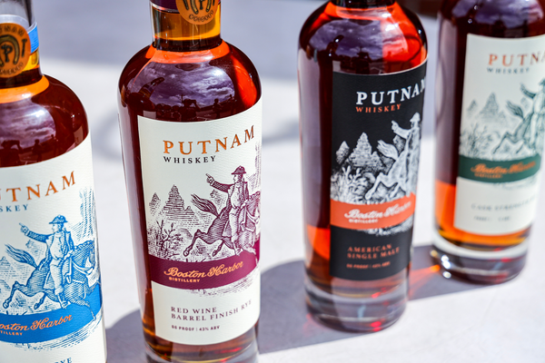 Image of four bottles of Putnam Whiskey. Straight Rye, Red Wine Barrel Finish Rye, American Single Malt and Cask Strength Rye